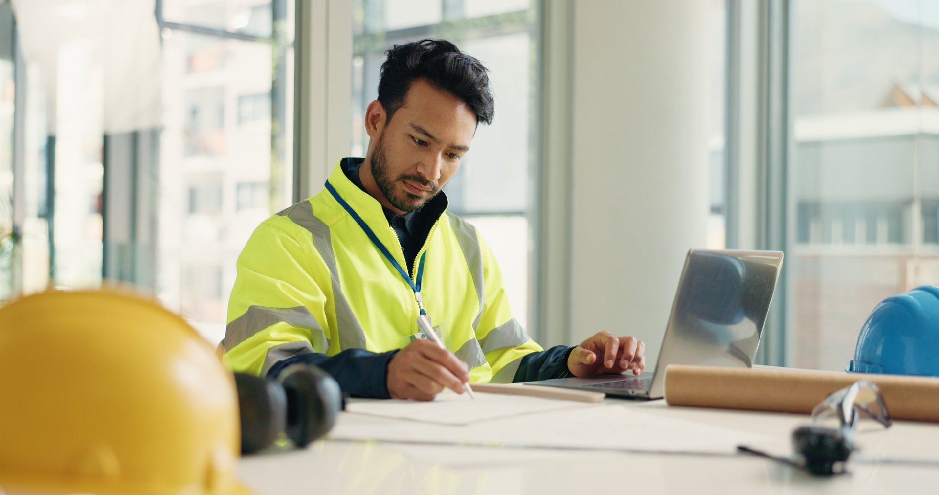 Architect reviewing building plans and blueprints on desk